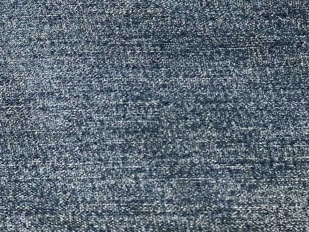 Close-up of a lightweight, breathable fabric with a subtle blue tone reflecting freshness.