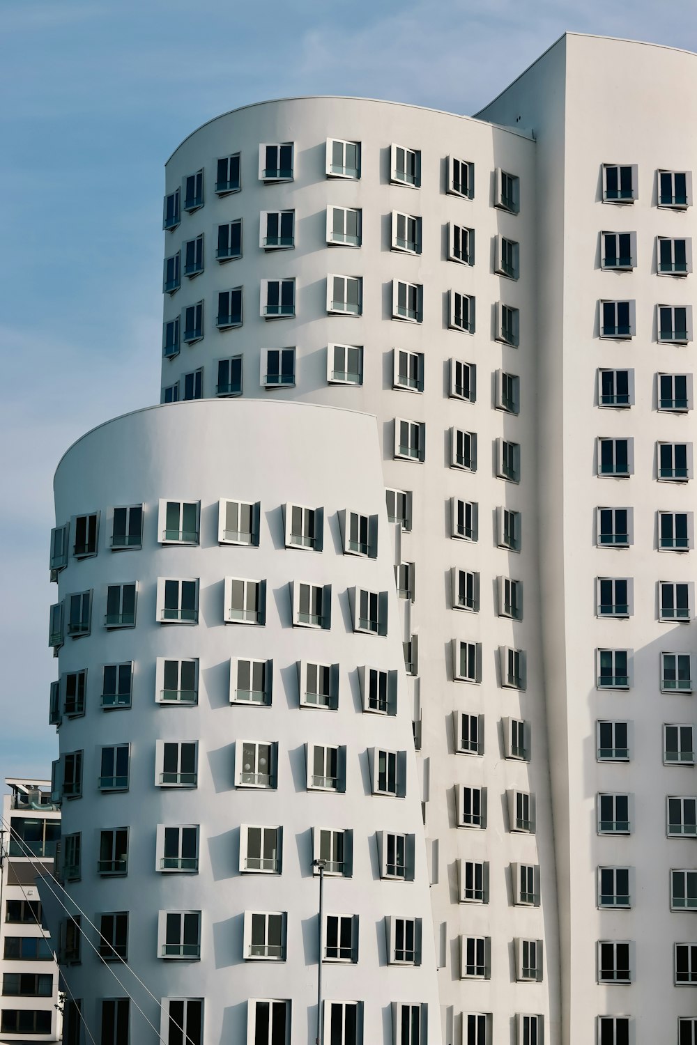 a tall white building with lots of windows