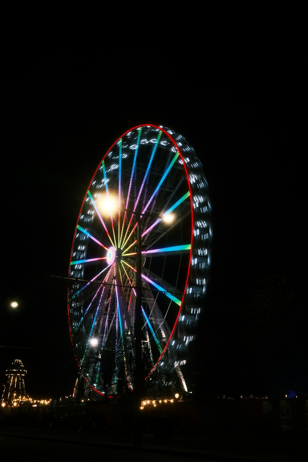 a large ferris wheel lit up at night