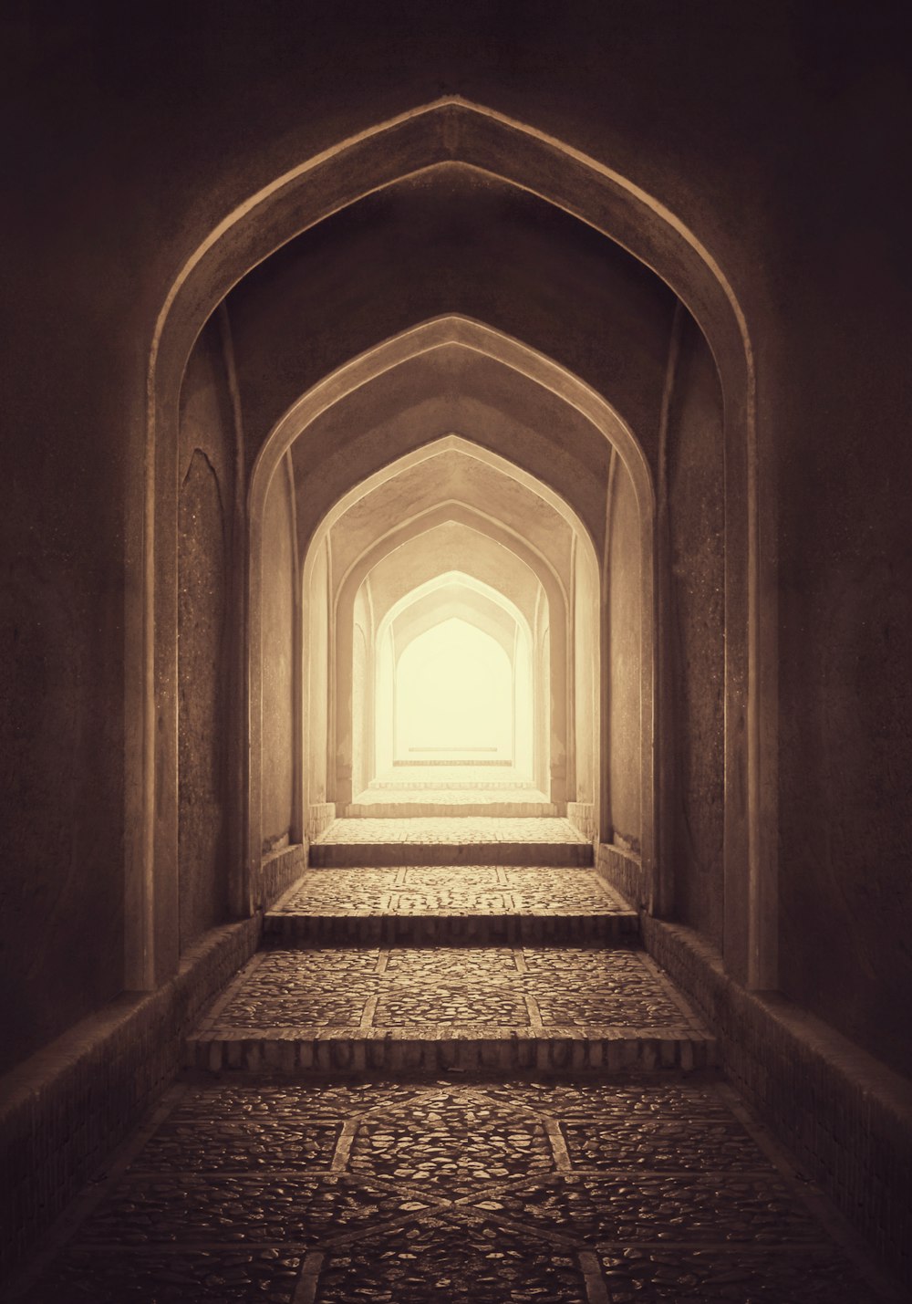 a long hallway with steps leading up to a window