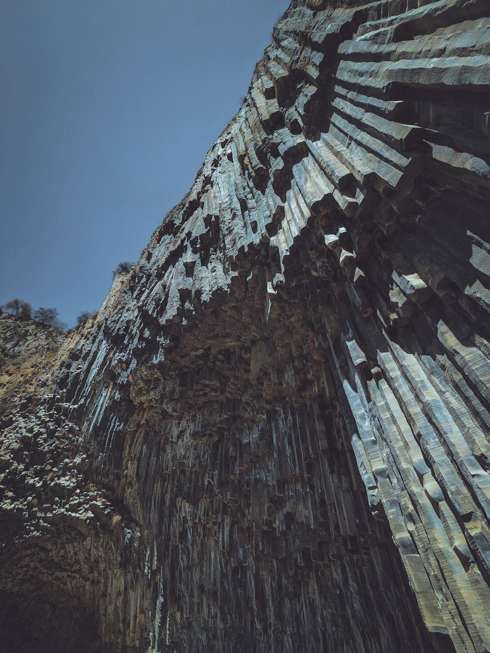 a very tall rock formation with a sky in the background