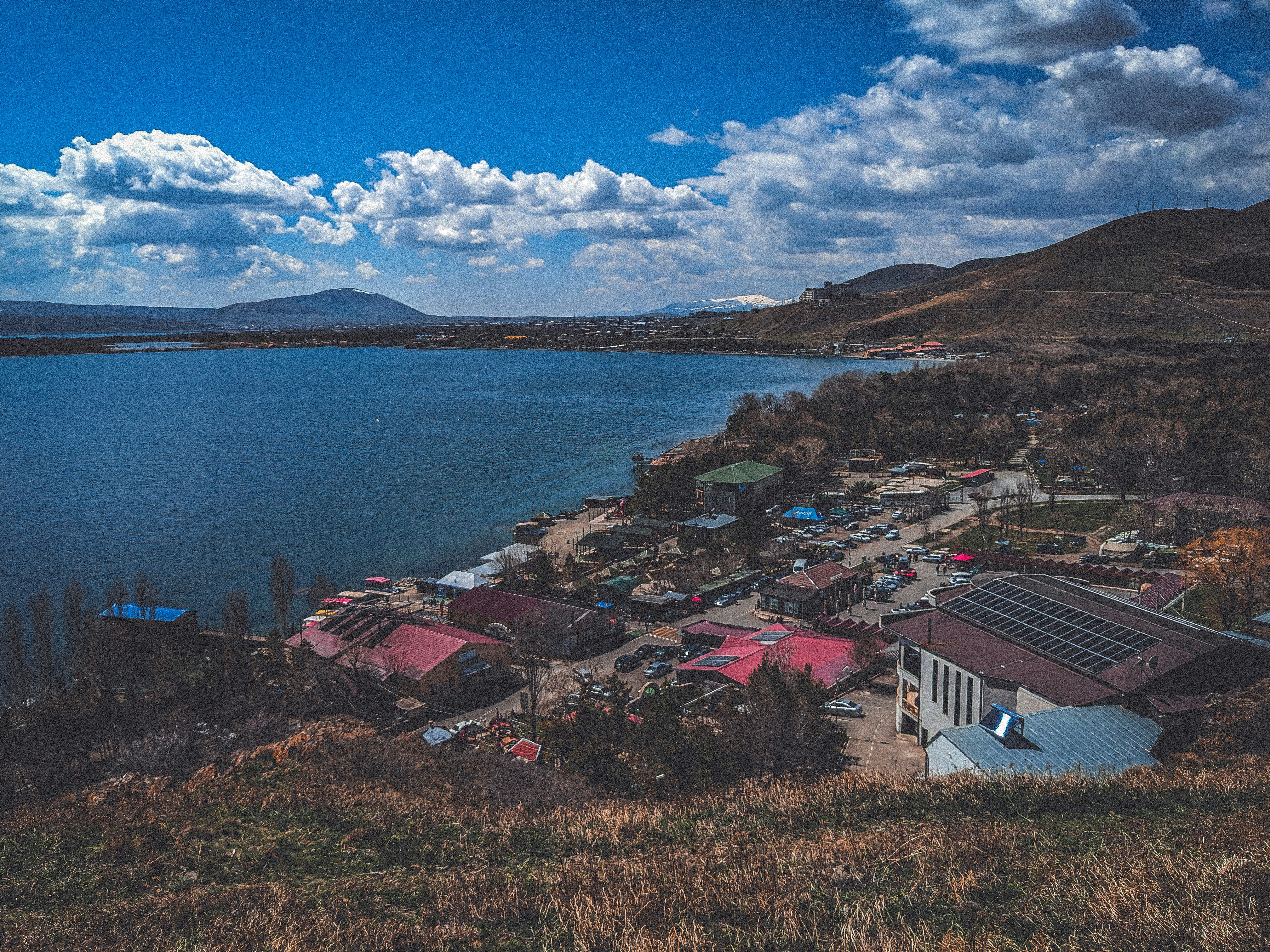 a view of a small town next to a body of water