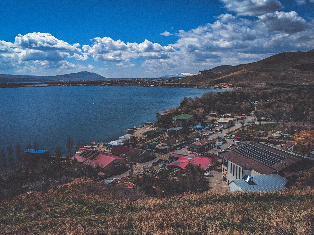 a view of a small town next to a body of water