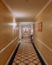 View of the hotel hallway leading to the Queen Suite entrance.