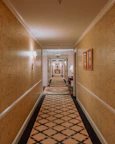 Luxurious hotel hallway with soft lighting and tasteful decor.