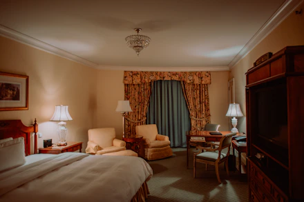Luxurious bedroom suite with plush furnishings and ambient lighting