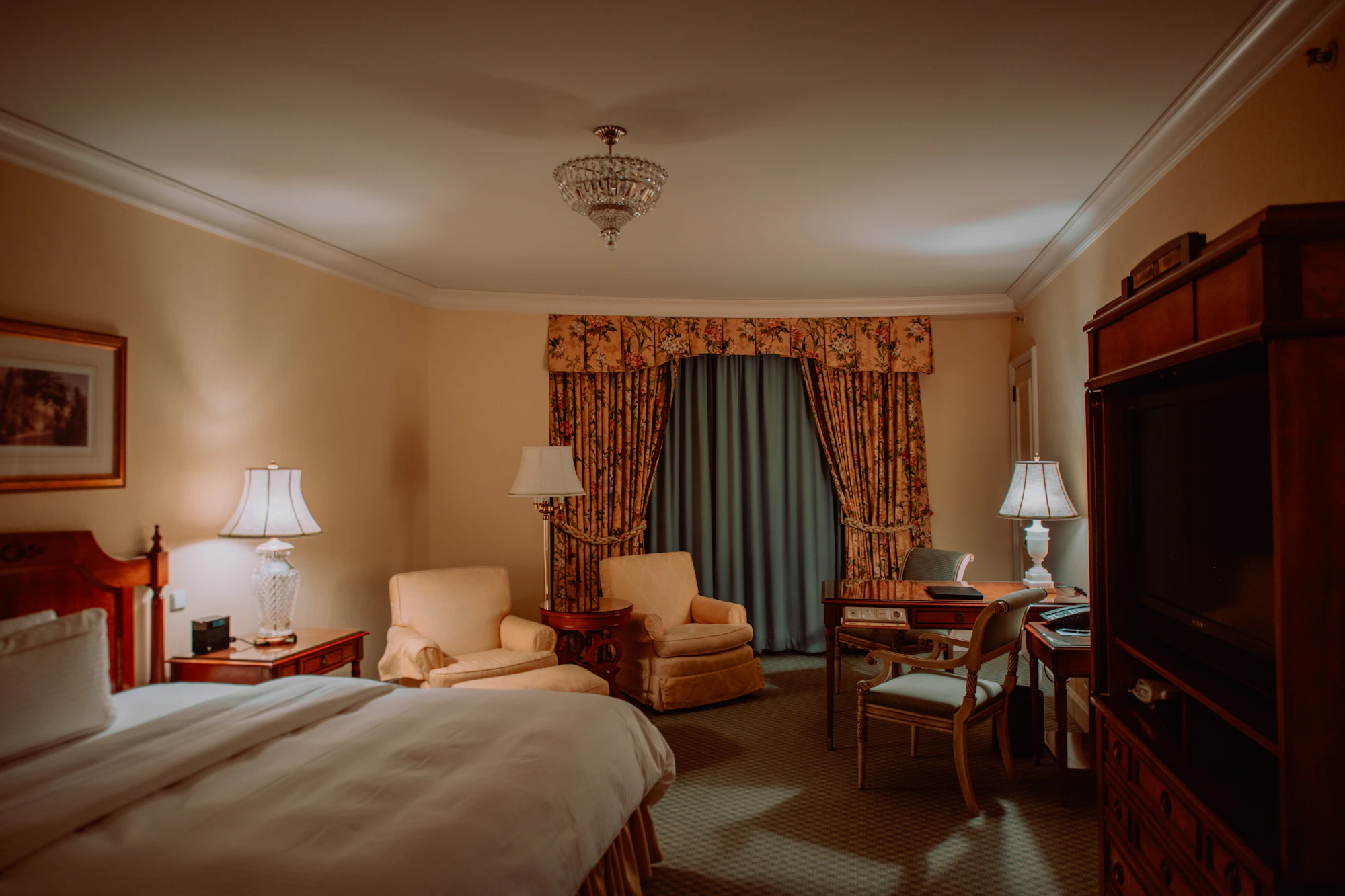 Elegant deep-toned European hotel suite with tailored furnishings