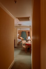 A serene hotel room with soft lighting and elegant decor, suggesting comfort and privacy.