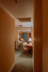 Elegant boutique hotel room with warm lighting and tasteful decor.
