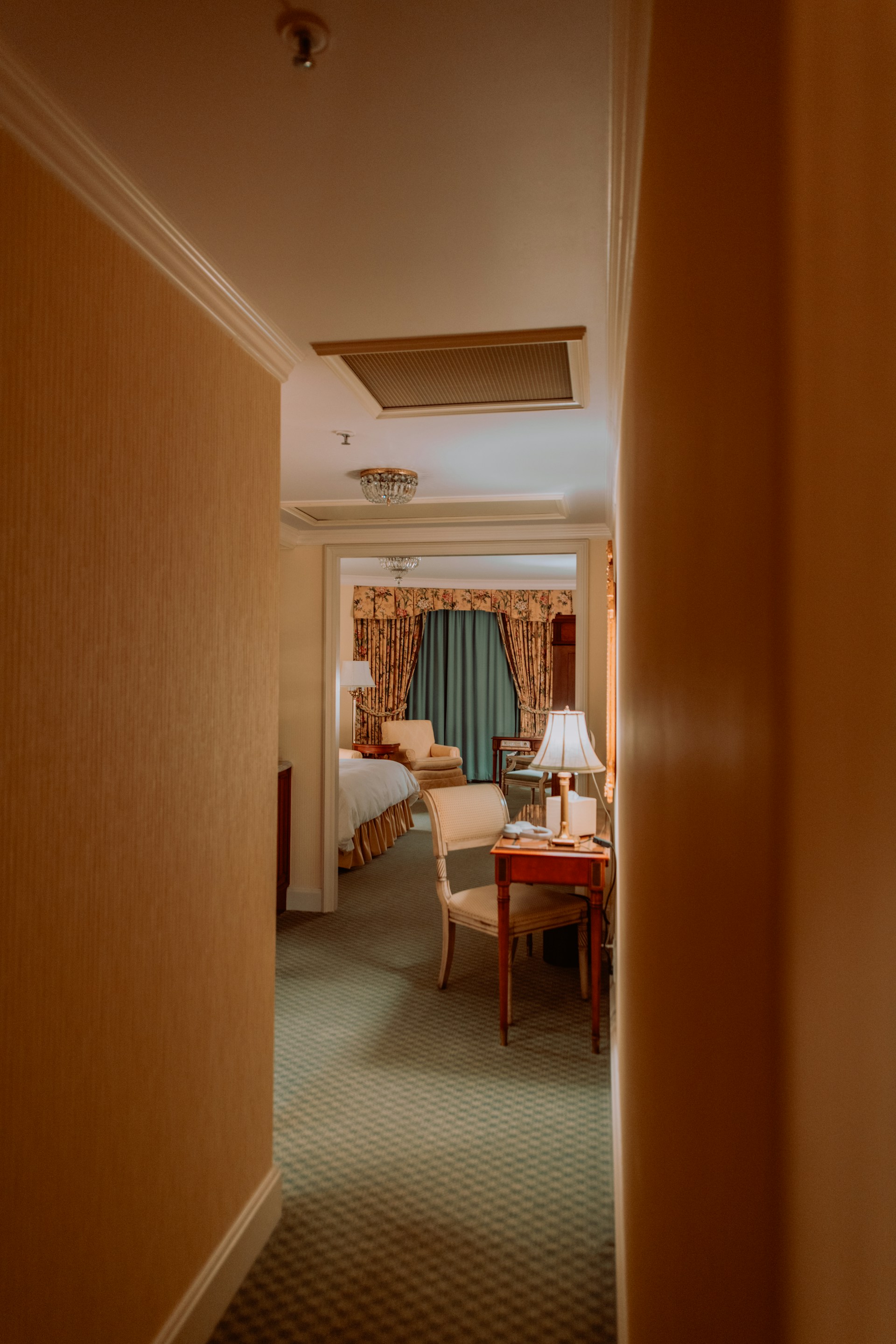 The elegant interior of a luxury AC room at Hotel The Rajaji, featuring modern decor and cozy lighting.
