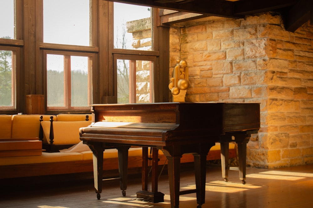 a piano sitting in front of a window in a living room