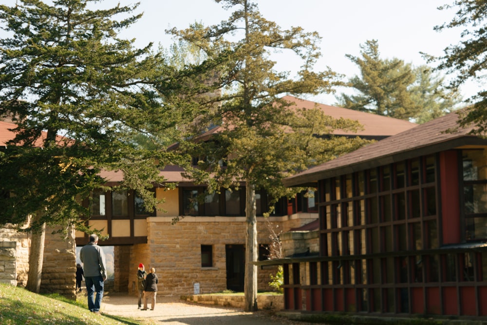 a man and a child walking down a path in front of a building