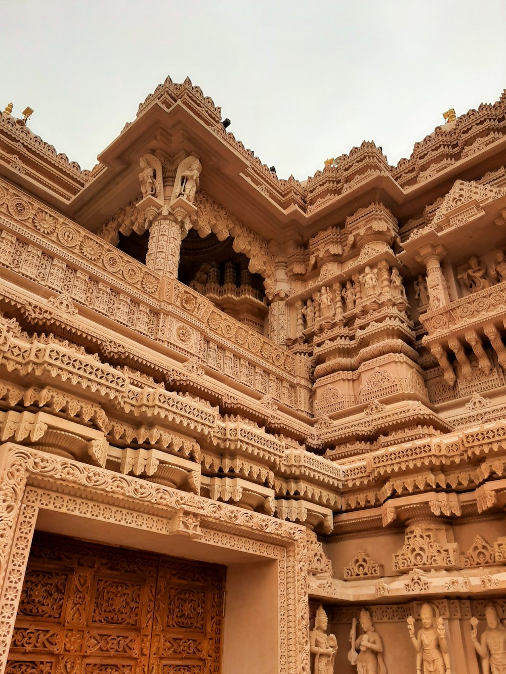 an intricately carved building with a wooden door