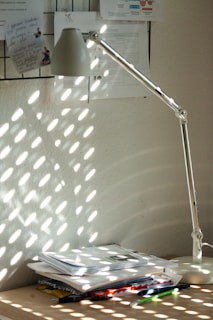 Sunlight streaming through a window onto a creative workspace with charts.