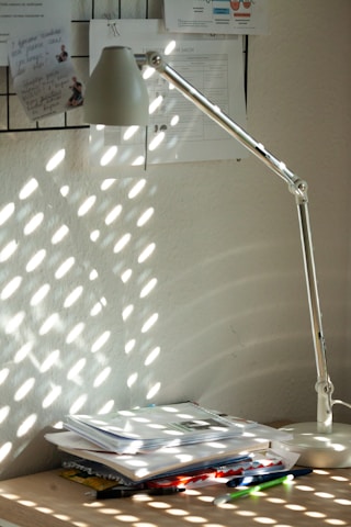 A bright morning scene with sunlight streaming through a window onto a cozy desk.