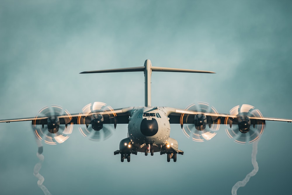 a large jetliner flying through a cloudy blue sky