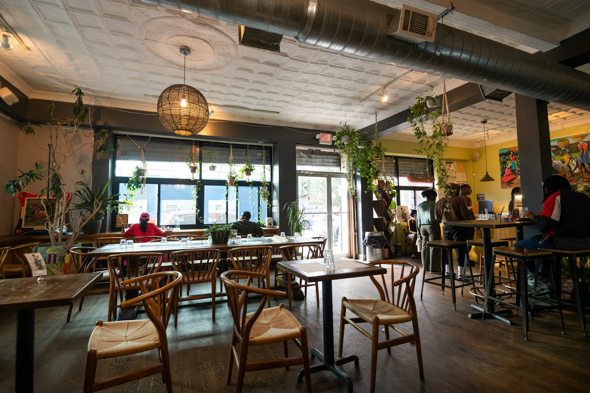 a restaurant filled with lots of wooden tables and chairs