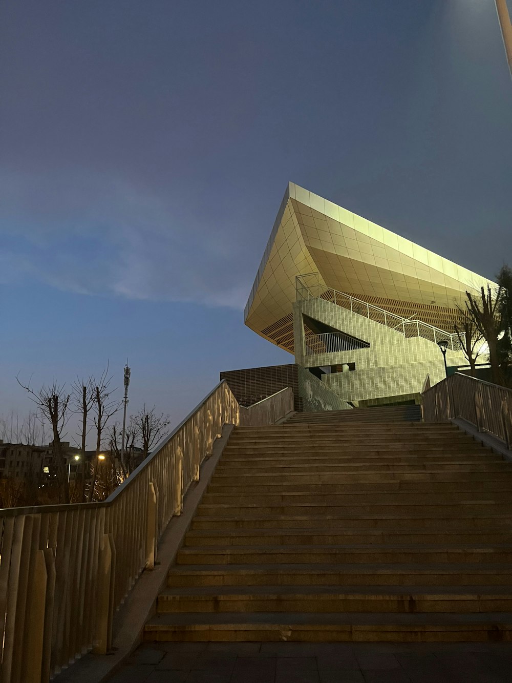 a staircase leading up to a building with a sky background