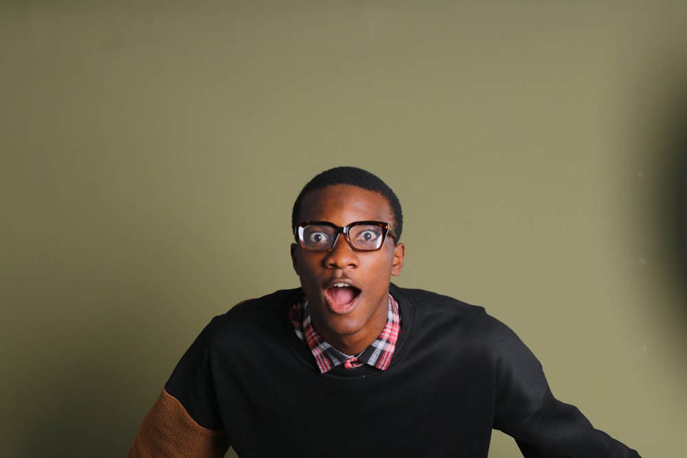 a man with glasses making a surprised face