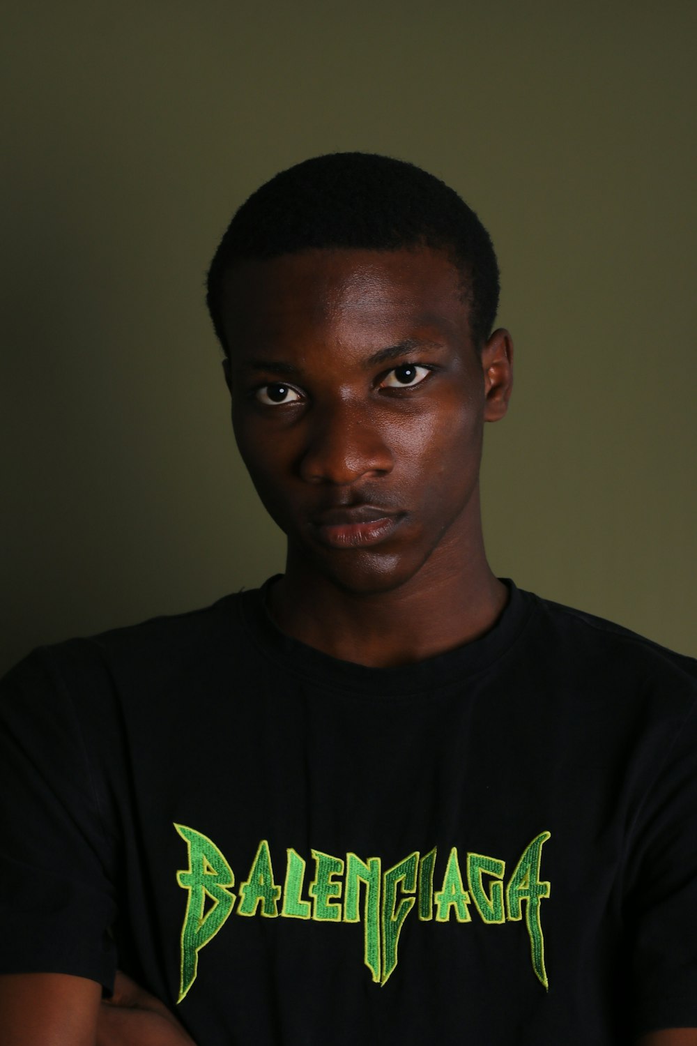 a man with a black shirt and green lettering on it