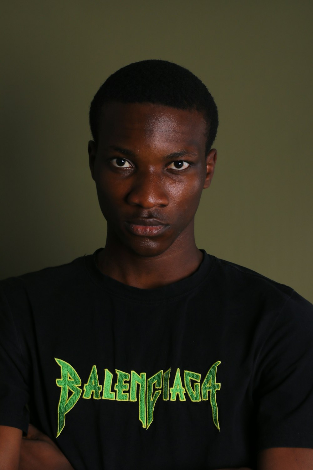 a man with a black shirt and green lettering on his shirt