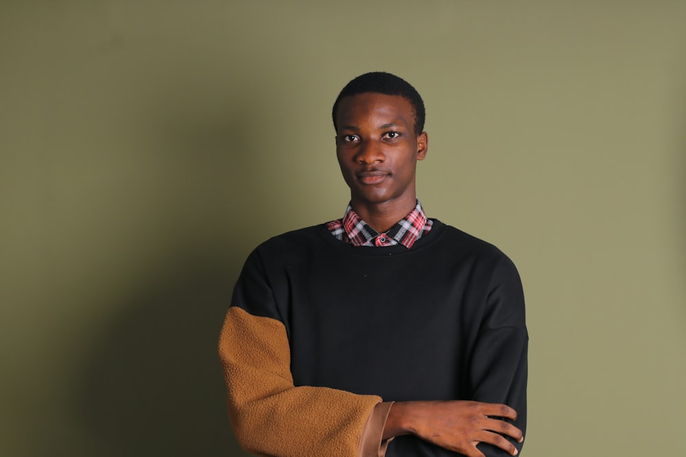 a man standing in front of a green wall