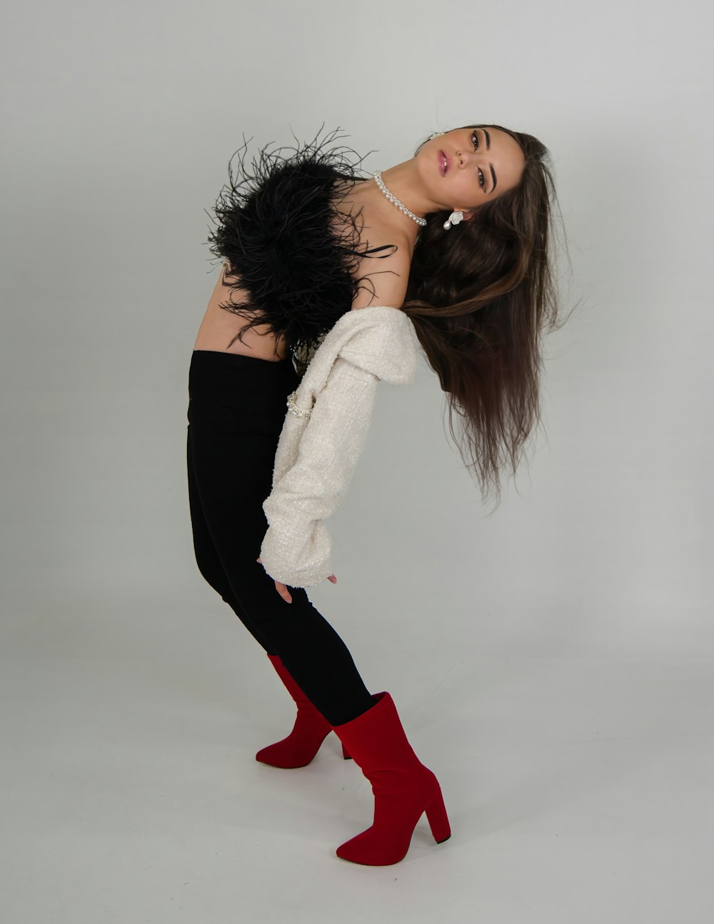 a woman with long hair and red boots