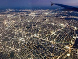 A sleek nighttime aerial view of Jakarta with glowing smart city data overlays.