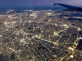 A dynamic aerial shot of a sprawling urban logistics hub illuminated at night.