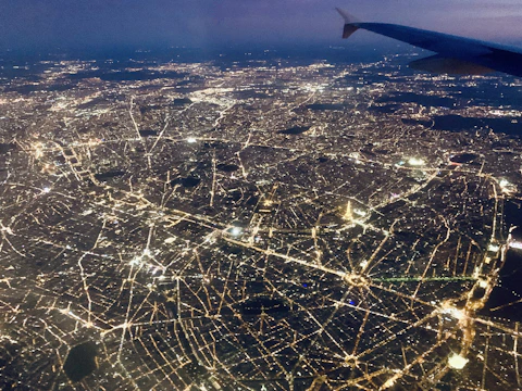 A dynamic aerial shot of a sprawling urban logistics hub illuminated at night.