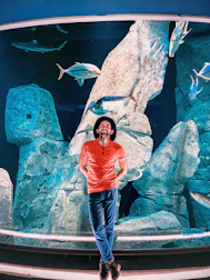 A smiling customer service representative ready to assist with aquarium questions.