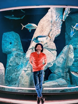 A customer support representative wearing a headset smiling while helping a caller about aquarium products.