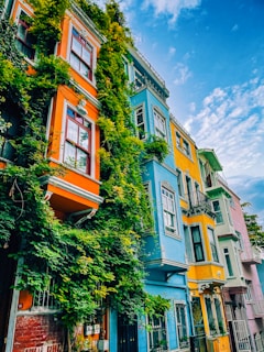 a row of multicolored buildings with a blue sky in the background