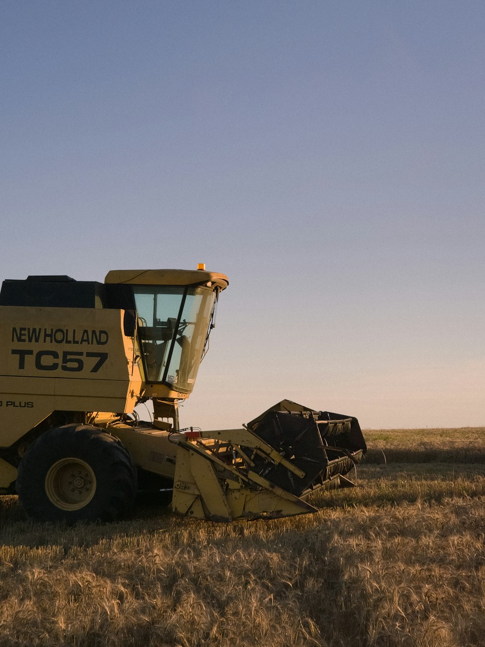 a large tractor is parked in a field