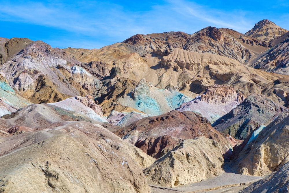 a mountain range with a blue sky in the background