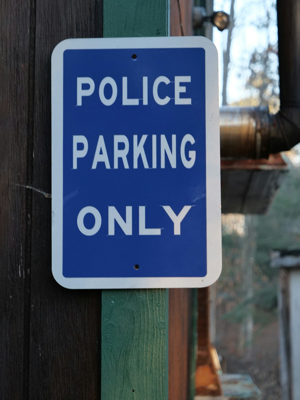 a police parking only sign attached to a telephone pole