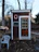 A neatly built wooden wendy house used as a small office space with a window open.