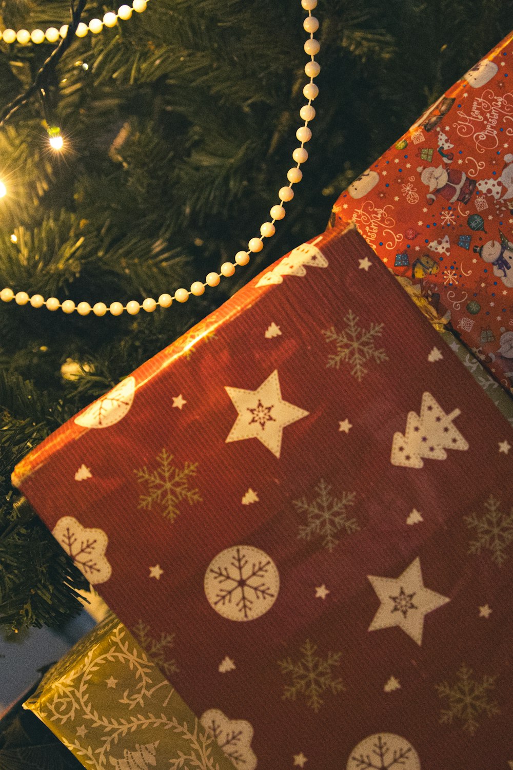 a close up of a christmas tree with presents under it