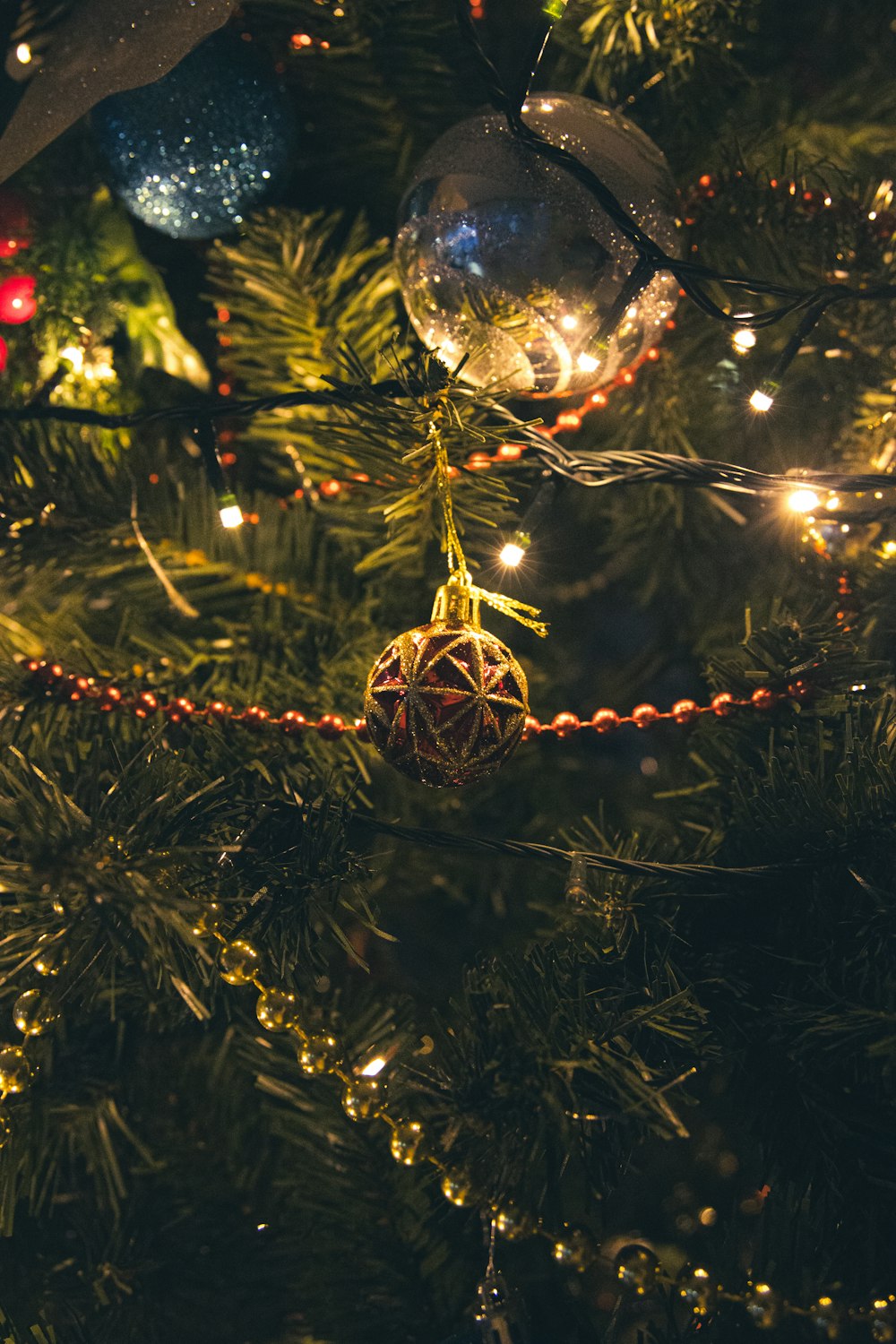 a close up of a christmas tree with ornaments