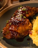 Golden roasted chicken with crispy skin served alongside creamy mashed potatoes.