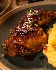 A generous plate of chicken fried chicken with creamy mashed potatoes and rich brown gravy dripping invitingly.