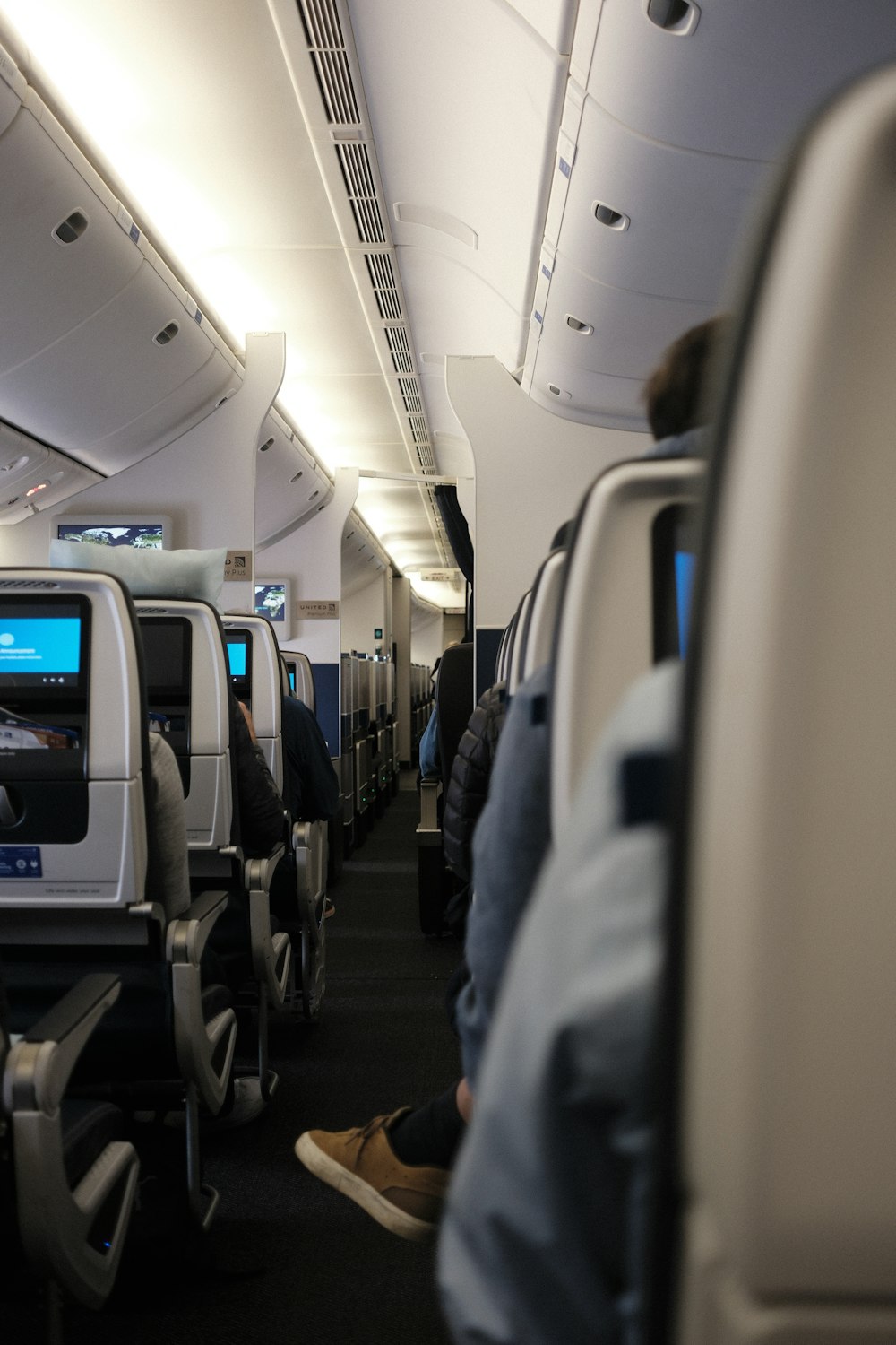 a row of seats on an airplane with people sitting on them