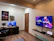 A cozy gaming room with a computer setup and gaming posters on the wall.
