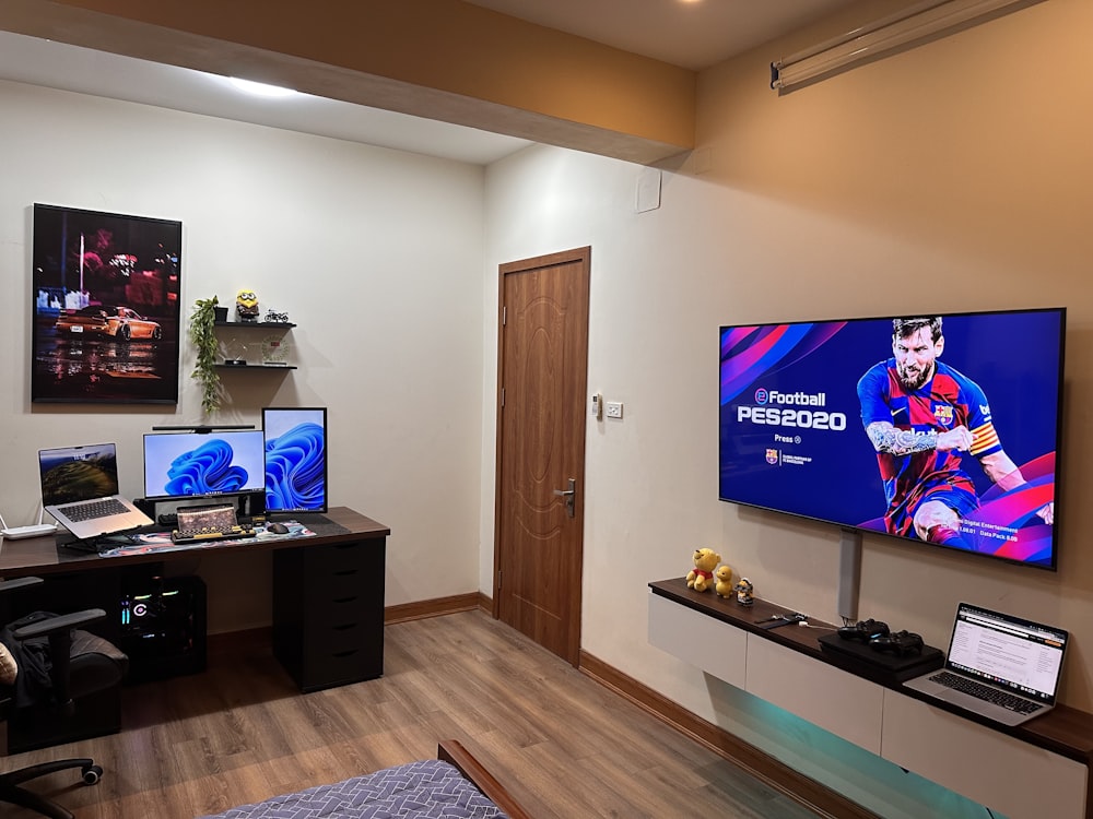 a flat screen tv sitting on top of a wooden desk