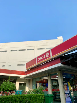 Wide view of a white and blue aguamax kiosk outside a Phoenix convenience store.