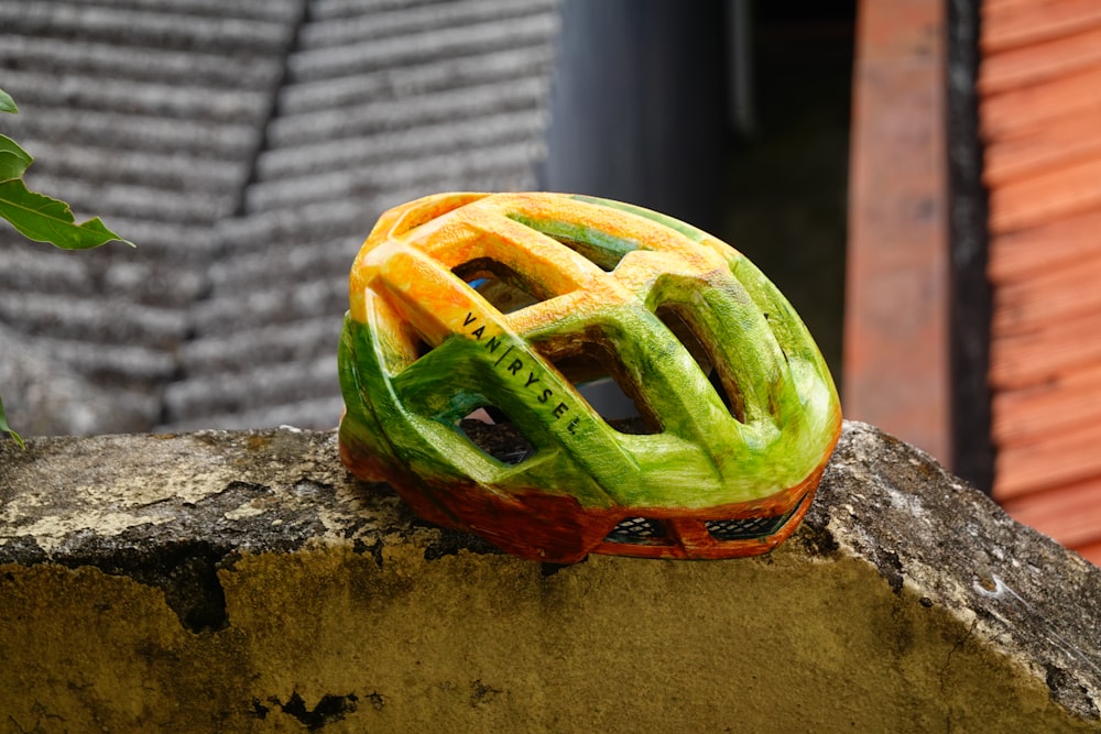 a bicycle helmet sitting on top of a stone wall