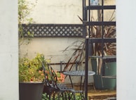 An elegant patio area featuring custom welding designs and outdoor furniture.