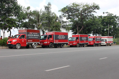 A fleet of Rodaviva trucks lined up ready for cargo transport in a city setting.