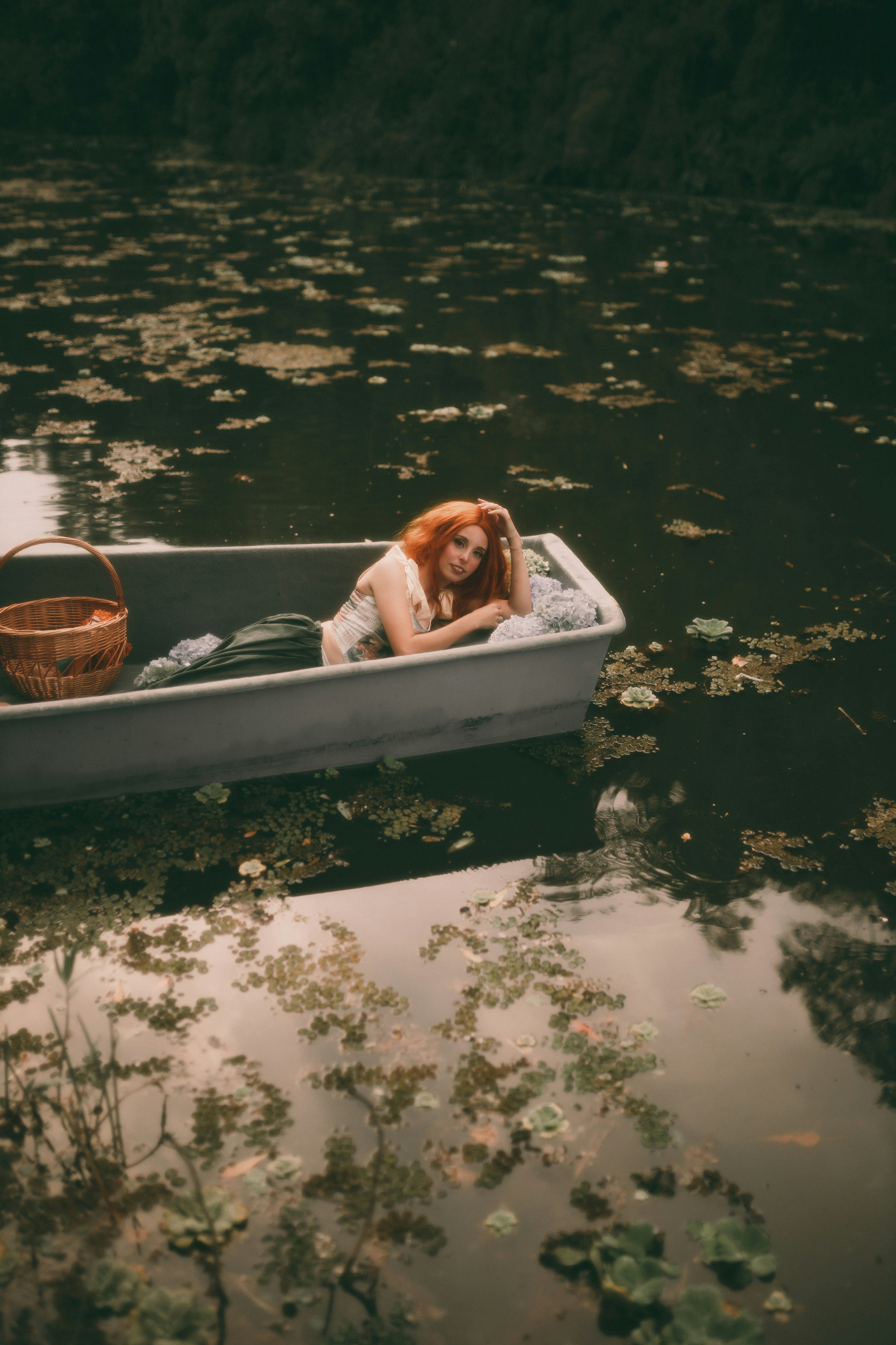 A woman sitting in a small boat on a lake photo – Free Photography ...