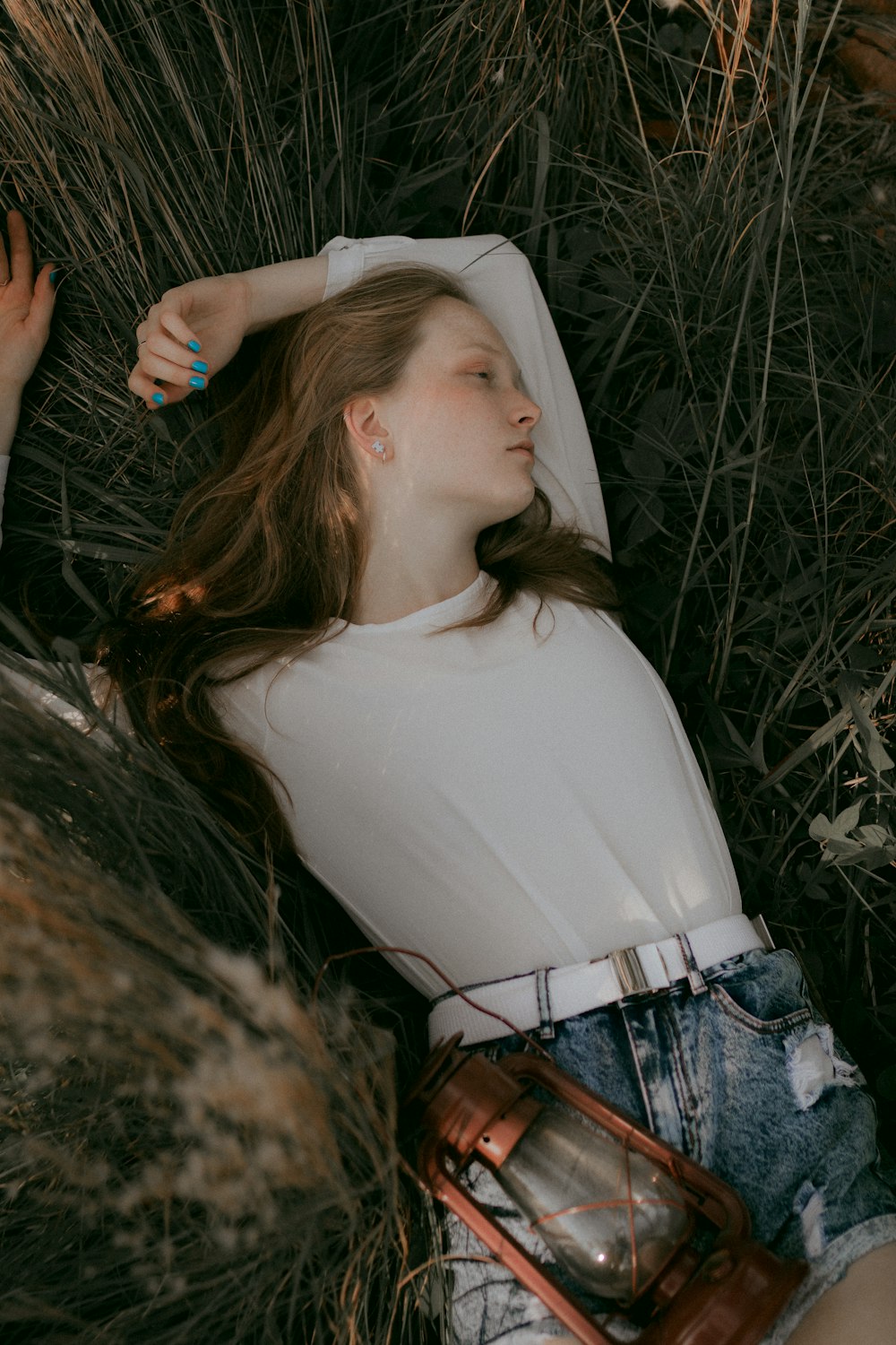 a woman laying in the grass with her head up